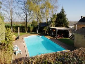 a swimming pool in the backyard of a house at Nuances d'Alcôves in Trévron