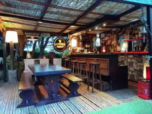 a bar with a wooden table and a bar counter at Nuances d'Alcôves in Trévron