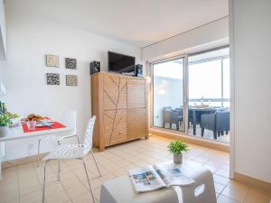 a living room with a table and a dining room at Apartment Les Trois Mâts-4 by Interhome in Canet-en-Roussillon