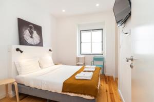 a bedroom with a bed with a tv on top at Gloria 10 in Lisbon