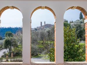 a view from an archway in a building at Holiday Home Podere Casina by Interhome in Sinalunga +83 photos
