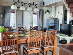 a dining room with a table and chairs at Holiday Home Loisteranta by Interhome in Vääräkoski