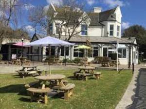 a group of picnic tables in front of a building at 37 Strawberry Hill, Hayle in Hayle