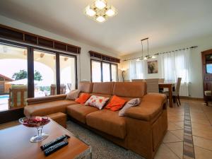 a living room with a brown couch and a table at Holiday Home Los Olivos by Interhome in Benimallunt