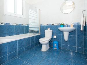 a blue tiled bathroom with a toilet and a sink at Villa elsa by Interhome in Protaras
