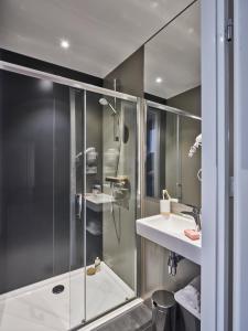 een badkamer met een douche en een wastafel bij Holiday Suites Limburg in Aan de Wolfsberg