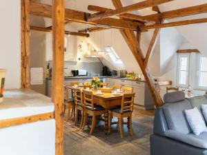 a kitchen and dining room with a wooden table and chairs at Holiday Home Tante Agnes by Interhome in Ediger-Eller