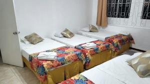 a room with two beds with towels on them at Ventnor House Apartments in Bridgetown