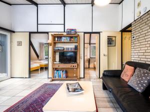 a living room with a couch and a table at Holiday Home Haus 11 by Interhome in Gerolstein