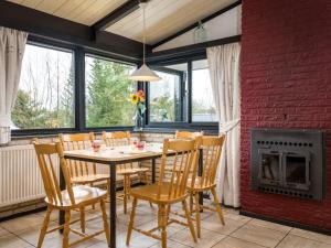 a dining room with a table and chairs and a fireplace at Holiday Home Haus 11 by Interhome in Gerolstein +29 photos