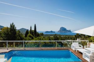a villa with a swimming pool and a view of the ocean at Villa Serretes in Cala Vadella