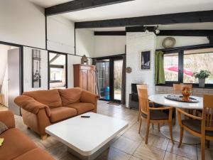 a living room with a couch and a table at Holiday Home Waldferienpark Gerolstein-16 by Interhome in Gerolstein