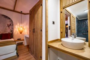 a bathroom with a sink and a bed in a room at Costa Bodrum City in Bodrum City