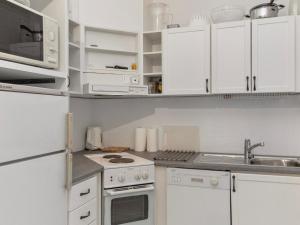 een keuken met witte kasten en een fornuis met oven bij Holiday Home Tahkontilhi b 6 by Interhome in Tahkovuori