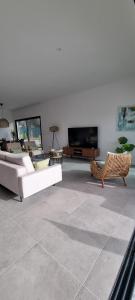 a living room with couches and a flat screen tv at Valverde 2 Villa, Vilamoura, Algarve, only 5 minutes from Marina, Golf and Beach in Vilamoura