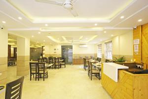 a restaurant with tables and chairs and a ceiling at Mayda Inn- A Boutique Hotel in New Delhi