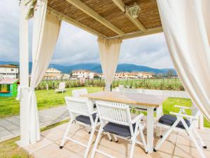 a table and chairs on a patio with a view at Holiday Home del Sole by Interhome in Bientina