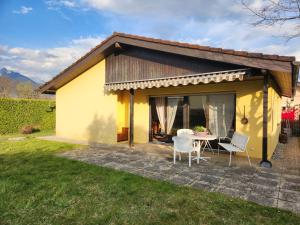 a small yellow house with a table and chairs at Holiday Home Dorenavant by Interhome in Bouveret