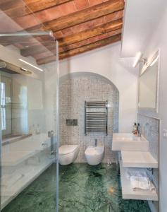 a bathroom with two sinks and a shower at Casale1918 in Pietrasanta