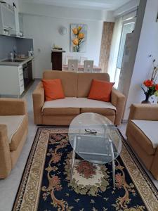 a living room with a couch and a table at Квартира in Igalo