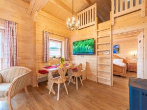 a dining room with a table and chairs in a log cabin at Holiday Home Chalet Toni mit Sauna by Interhome in Spiegelau +38 photos