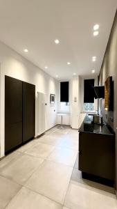 a large kitchen with black cabinets and a tile floor at Apartment via Ferrucci 22 in Milan