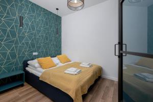 ein Schlafzimmer mit einem Bett mit Handtüchern darauf in der Unterkunft Apartament LAZUROWY Bridge Apartments & Spa z basenem Dziwnów EPapartamenty in Dziwnów + 99 Fotos
