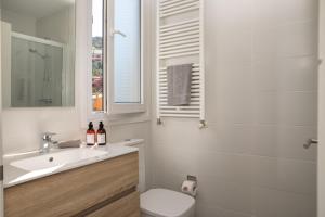 a bathroom with a sink and a toilet and a mirror at Casa Ciudamar Costa Brava - BY EMERALD STAY in Begur +35 photos