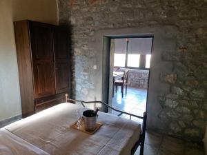 a room with a table in a stone wall at Petra kai Elia in Oitylo