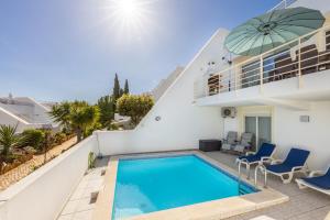 a villa with a swimming pool and a balcony at Casa Melancia in Luz
