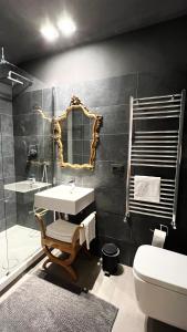 a bathroom with a sink and a mirror and a toilet at Apartment via Ferrucci 22 in Milan