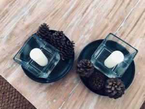 two plates with candles and pine cones on a table at Mawella House 1807, Tangalle in Tangalle +41 photos
