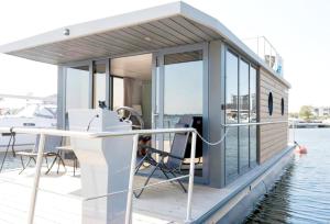 a small cabin on a boat in the water at Hausboot Luv in Flensburg