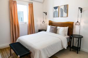 a bedroom with a white bed and a window at N1 Condos in San Juan