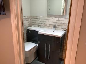 a bathroom with a sink and a toilet at Jeffersons Hotel & Serviced Apartments in Barrow in Furness