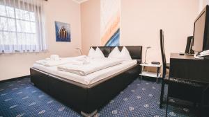 Postel nebo postele na pokoji v ubytování Hotel Kärntnerhof Velden by S4Y