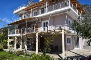 a large white house with a balcony at Studio Holiday Kalamata 2 in Kalamata