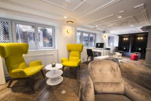 a living room with yellow chairs and a desk at Vertigo Hotel, By Marriott, a Member of Design Hotels in Dijon +37 photos