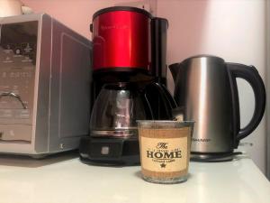 a coffee cup sitting next to a coffee maker at Pereybere Holiday Apartment in Pereybere