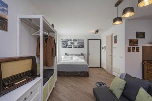 a bedroom with a bed and a tv in a room at Acquarium Studio by Wonderful Italy in Genoa