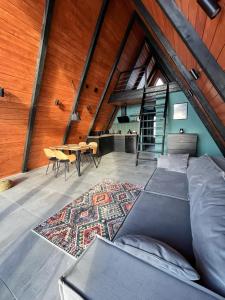 an attic room with a bed and a table at Mirador Cottage in Slavske