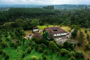an aerial view of a house in a field at Hotel Hacienda Supracafe in Popayan