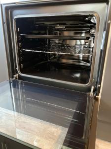 an oven with its door open in a kitchen at Byelands Lodge in Middlesbrough