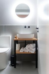 a bathroom with a sink and a pile of towels at Albatros in Puentedeume