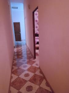 a hallway with a tile floor in a room at Tamuna Guest House in Martvili