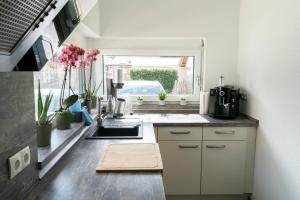 a small kitchen with a sink and a window at Villa Preisendanz in Ringsheim