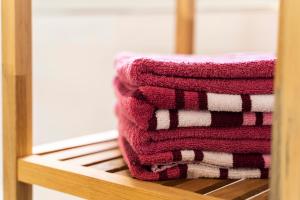 a stack of towels sitting on a wooden shelf at Villa Preisendanz in Ringsheim