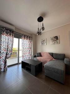 a living room with a couch and a table at EVa's Luxury Apartments No 4 in Artemida