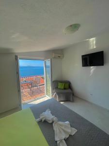 a bedroom with a bed and a view of the ocean at Apartmani ABA in Stanići +19 photos