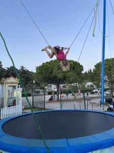een vrouw die op een trampoline springt bij Floating Sea House MAREA in Portorož